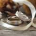 Elegant wedding rings adorned with delicate ribbon and floral ac