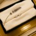 Close-up of classic diamond stud earrings on silk