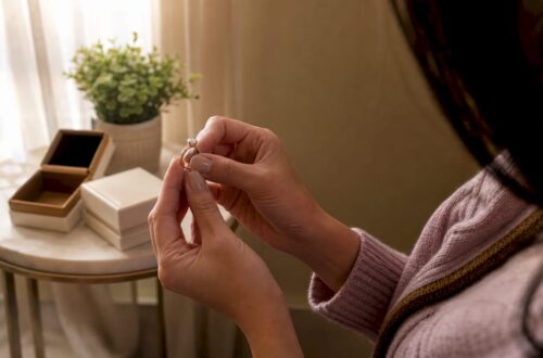 Close-up of two-tone engagement ring held in hands