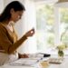 Woman comparing engagement ring metals at home