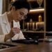 Jeweler inspecting diamond with GIA report