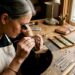 Hands setting birthstones on gold mother's ring