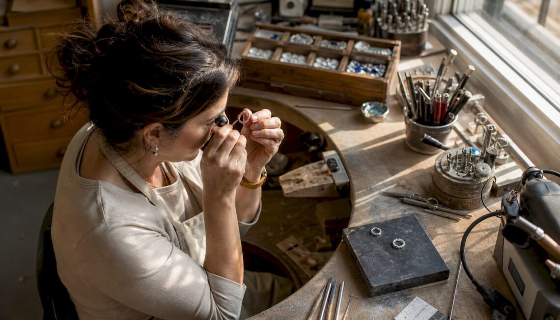 Jeweler inspecting a ring prototype in workshop