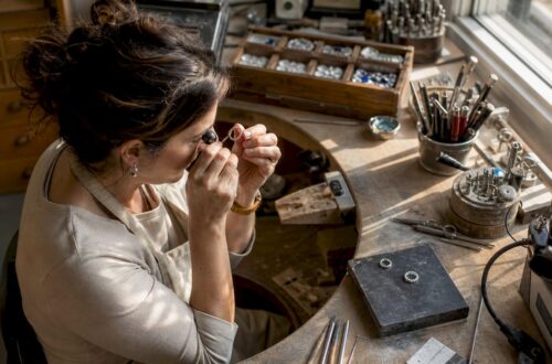 Jeweler inspecting a ring prototype in workshop
