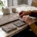 Hands arranging affordable luxury jewelry on table