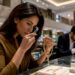Customer inspecting jewelry with jeweler's loupe
