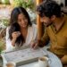 Couple browsing personalized jewelry options at home