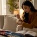 Woman examining engagement ring settings at dressing table