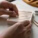 Hands placing lab-grown diamond on tray