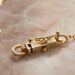 Close-up of child's gold necklace box clasp with safety catch