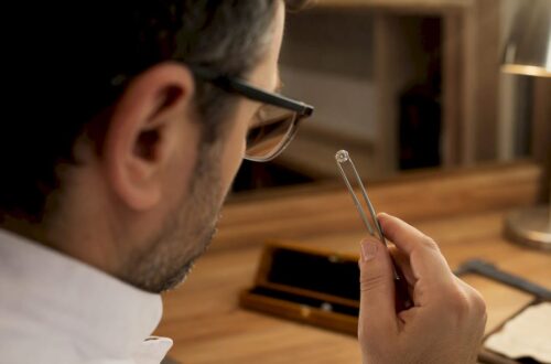 Close-up of hand inspecting diamond clarity