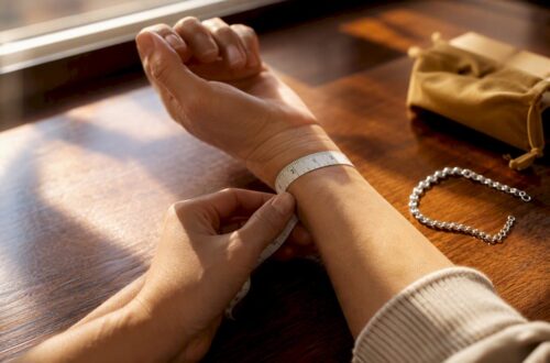 Hands measuring wrist with cloth tape