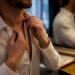 Man checking chain placement at collar