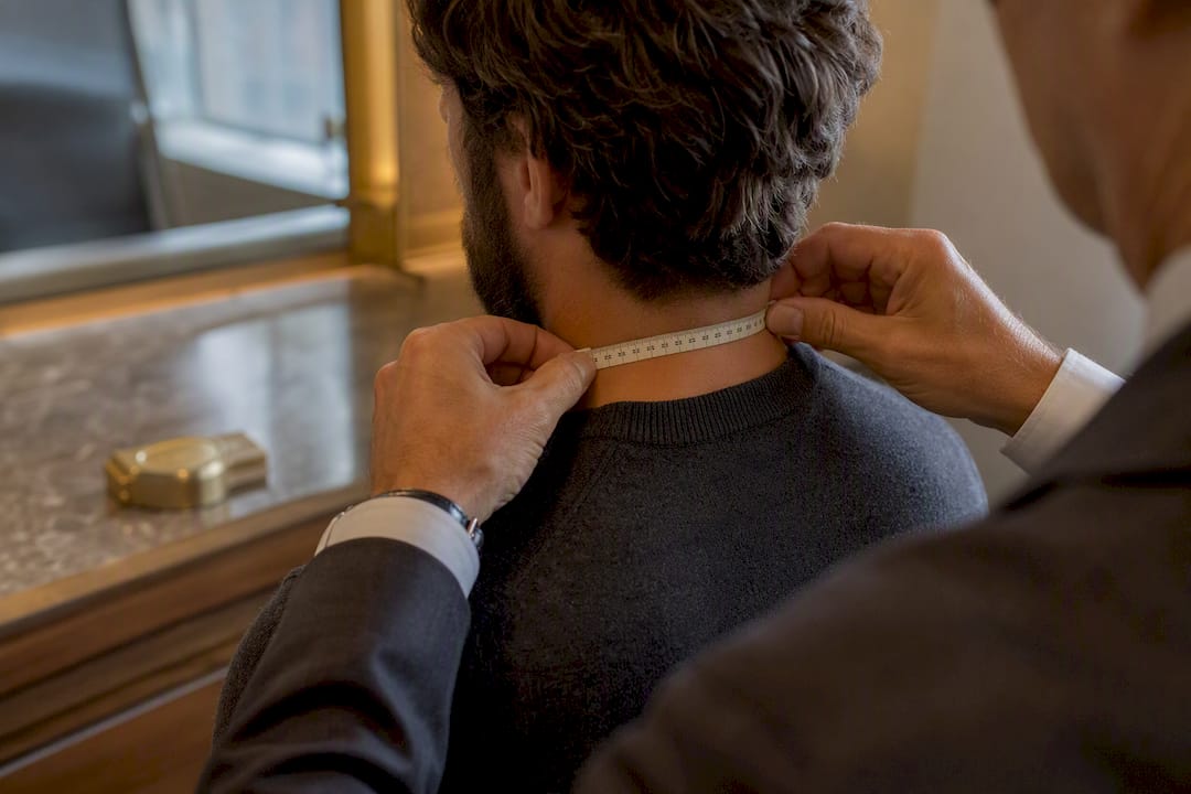 Tape measuring a man’s neck circumference