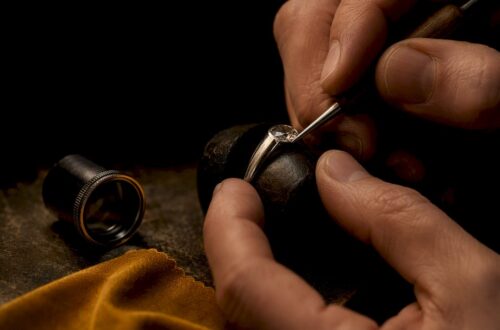 Jeweler burnishing a flush-set gemstone