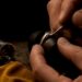 Jeweler burnishing a flush-set gemstone