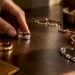 Hand arranging mixed metal jewelry pieces