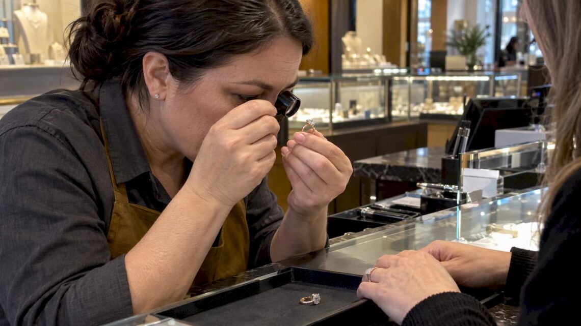 Jeweler inspecting a diamond ring for trade-in