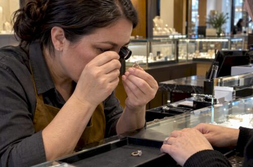Jeweler inspecting a diamond ring for trade-in
