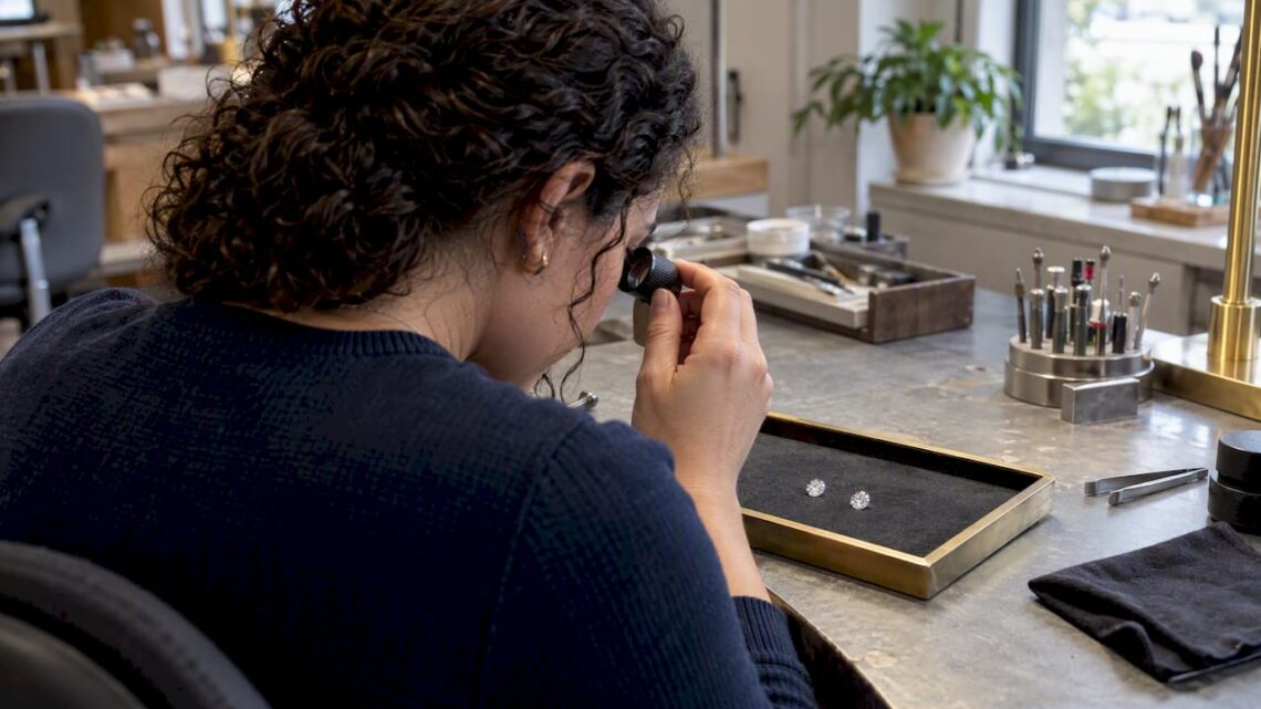 Buyer comparing two diamonds with a loupe