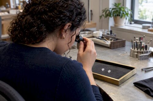 Buyer comparing two diamonds with a loupe