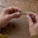 Hands comparing half and full eternity bands
