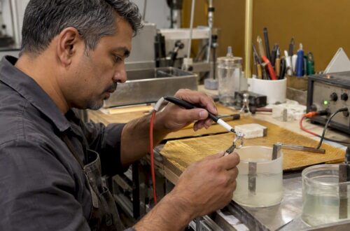 Jeweler applying rhodium plating to a ring