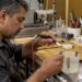 Jeweler applying rhodium plating to a ring
