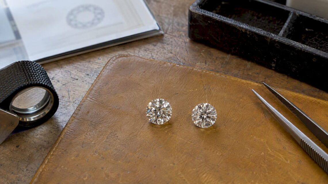 Loose diamonds beside a grading report