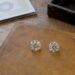 Loose diamonds beside a grading report