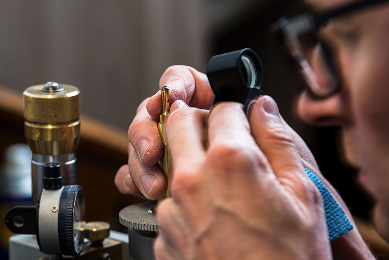 GIA certified gemologist examining a diamond at USA Jewels