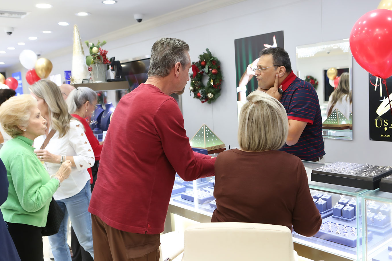 Customer and staff member in conversation at jewelry counter