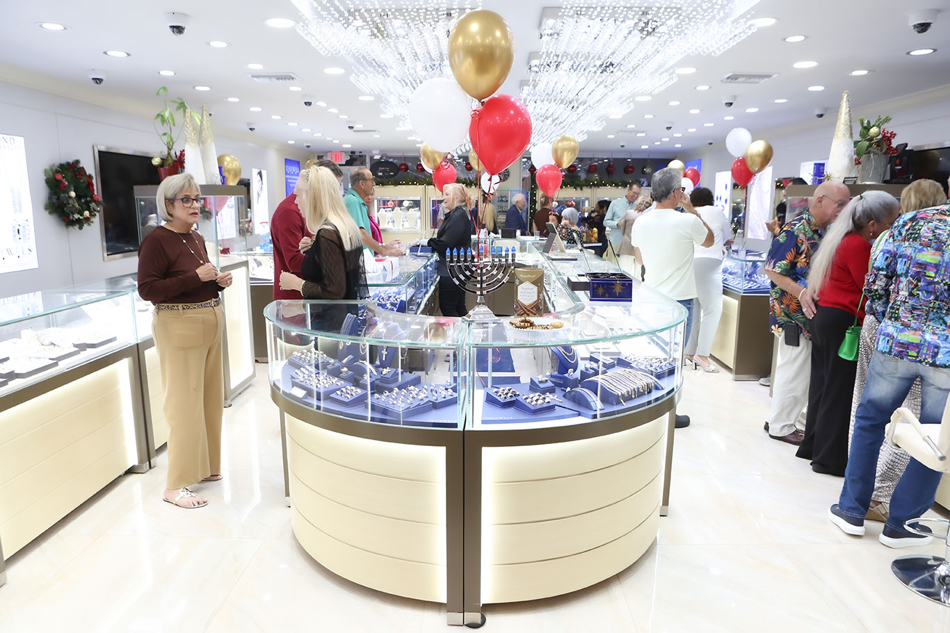 Guests mingling at the center display during holiday open house