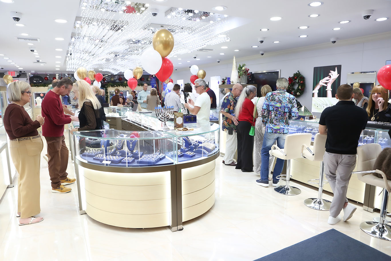 Wide shot of USA Jewels holiday celebration with crystal ceiling and display cases