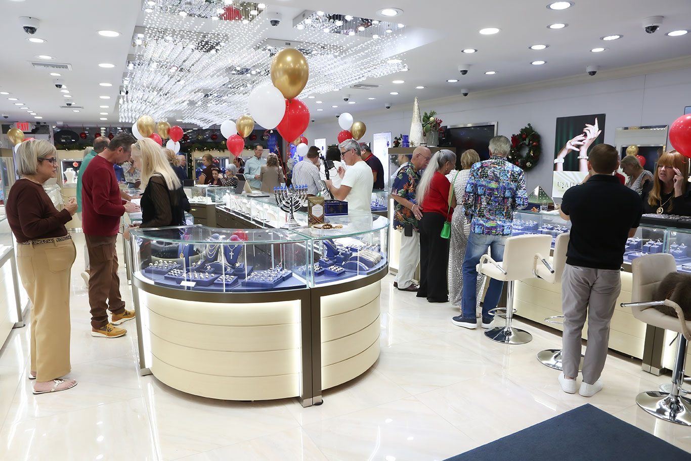 Guests browsing jewelry displays at USA Jewels holiday event