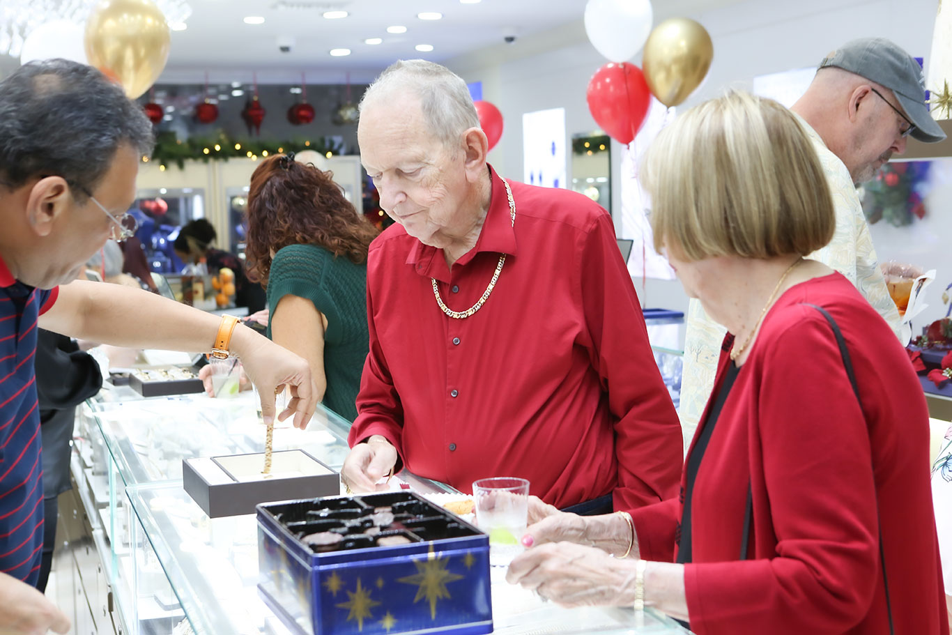 Guests socializing at USA Jewels holiday open house