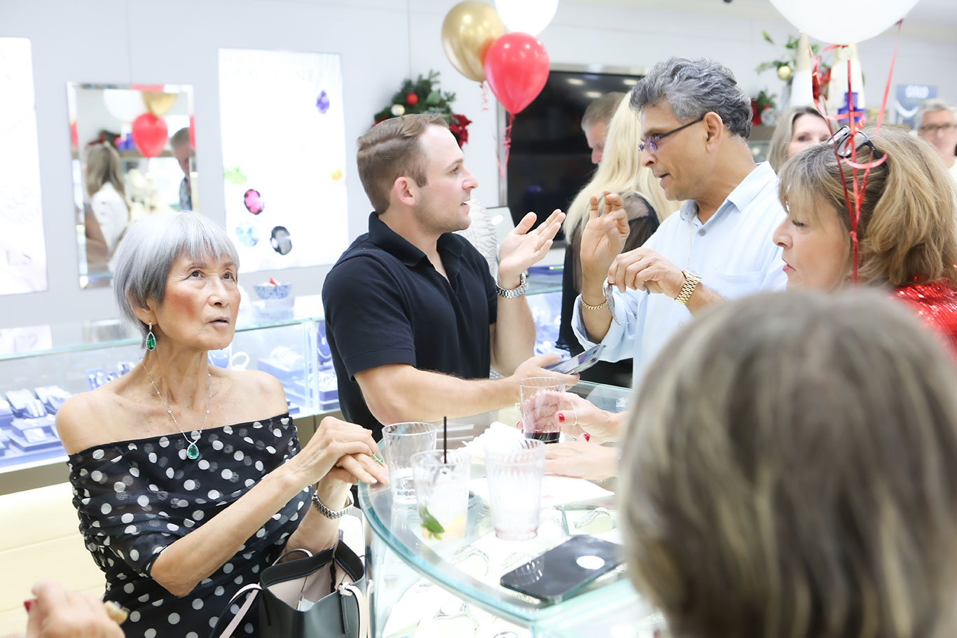 Guests engaged in lively conversation at holiday open house