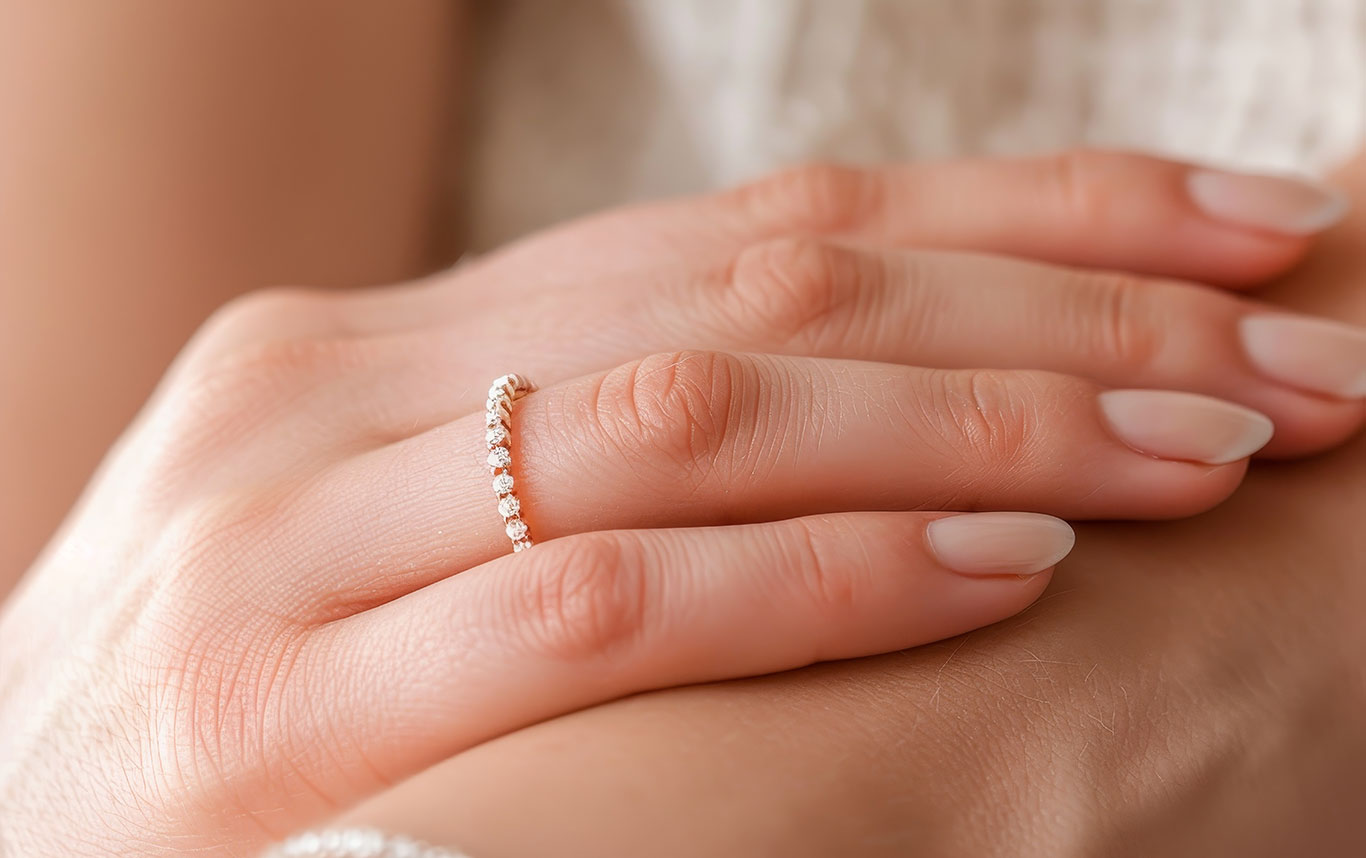 Women's wedding bands featuring diamond pave bands, eternity rings, contoured bands, and stackable gold and platinum rings