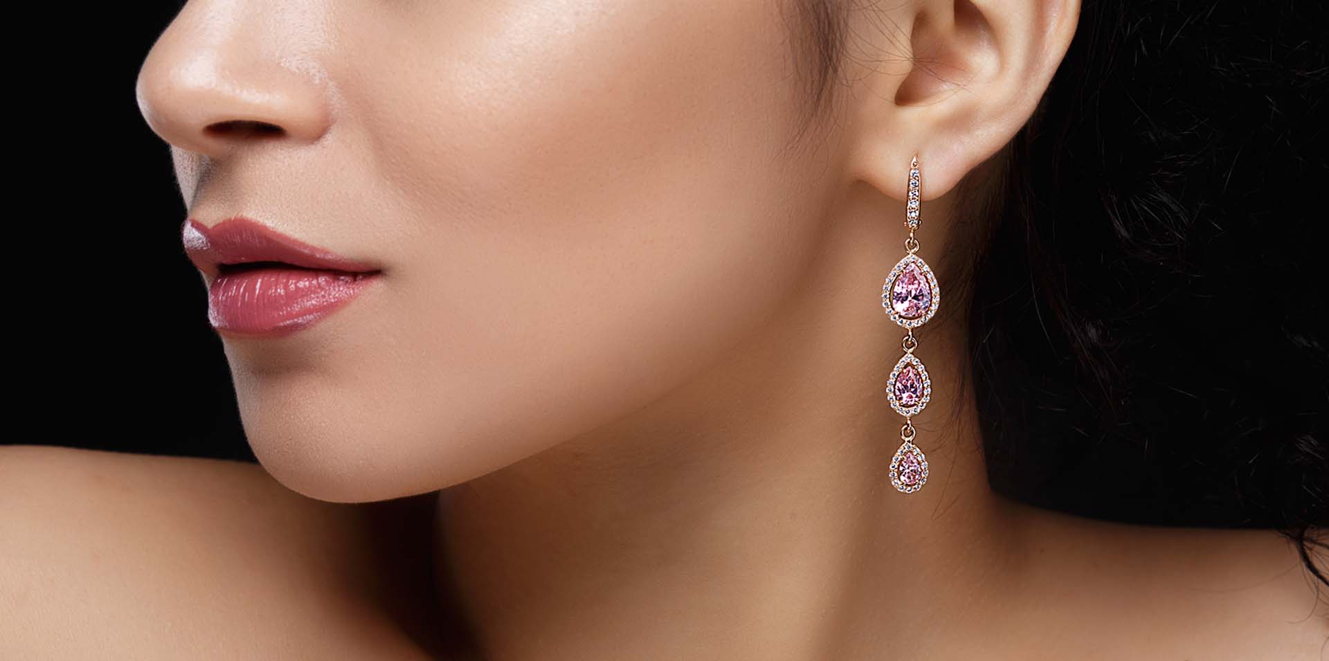 Beautiful woman with hanging 3 tone pear shaped pink diamond earrings: Telephone number 1-877-872-9909