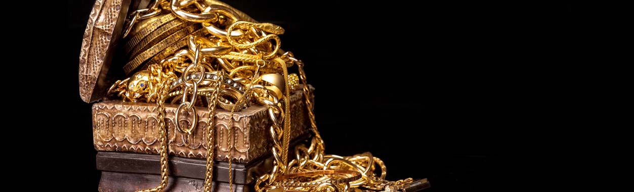 Gold Jewelry Box with lots of gold chains hanging out of the box: Telephone number 1-877-872-9909