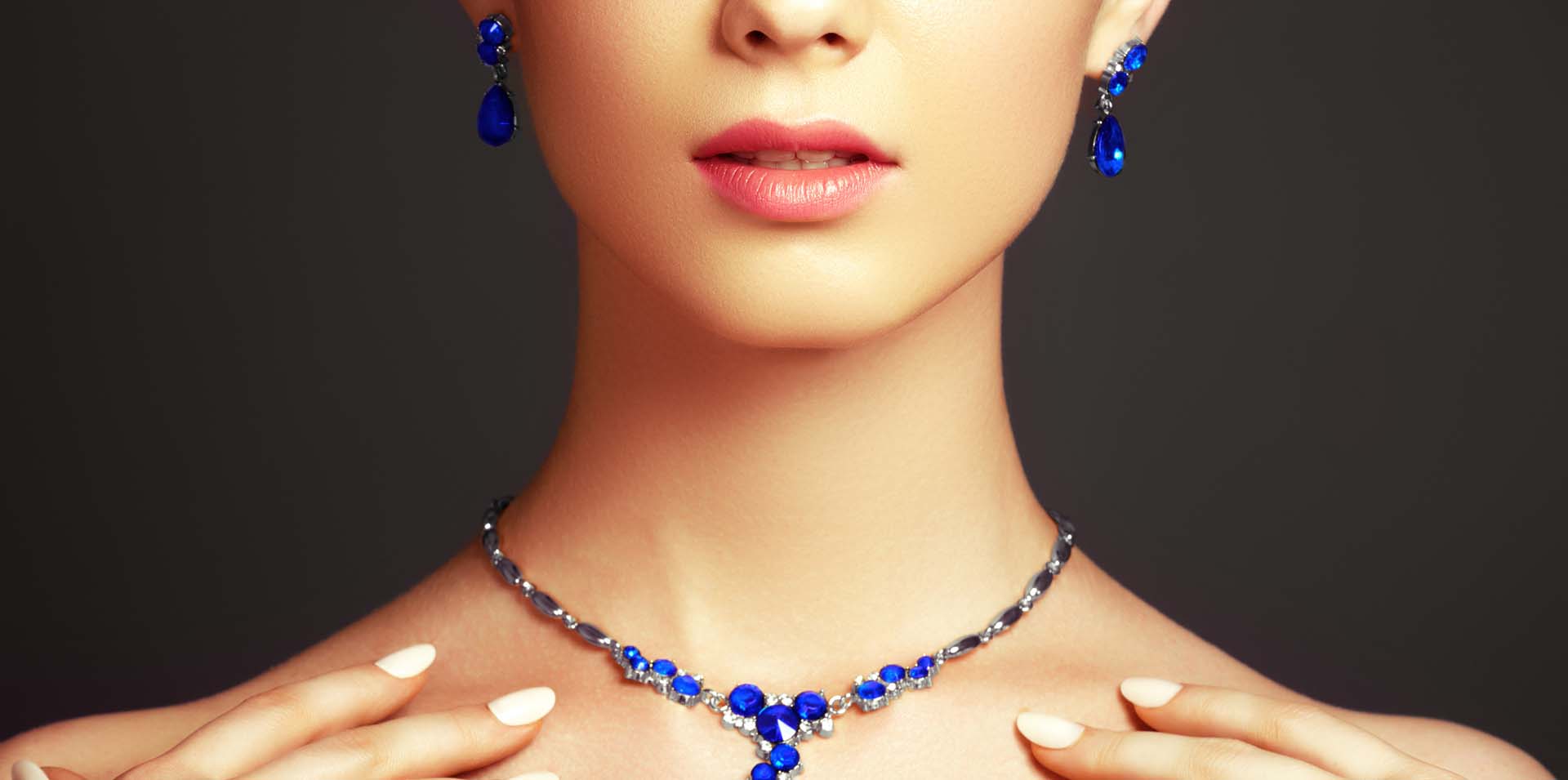 A woman modeling sapphire jewelry: Telephone number 1-877-872-9909